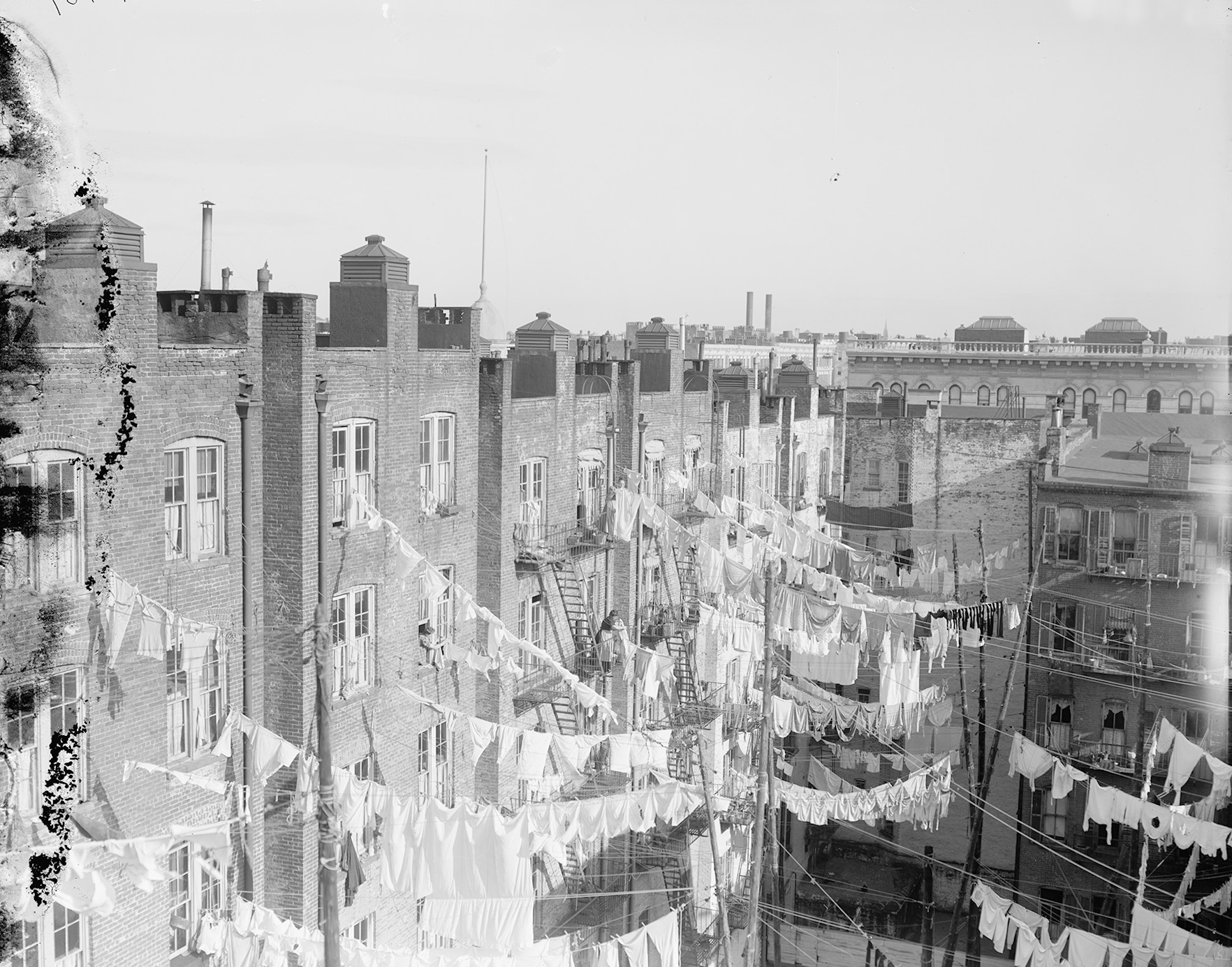 View into the yard of a tenement housing complex in New York. NY.