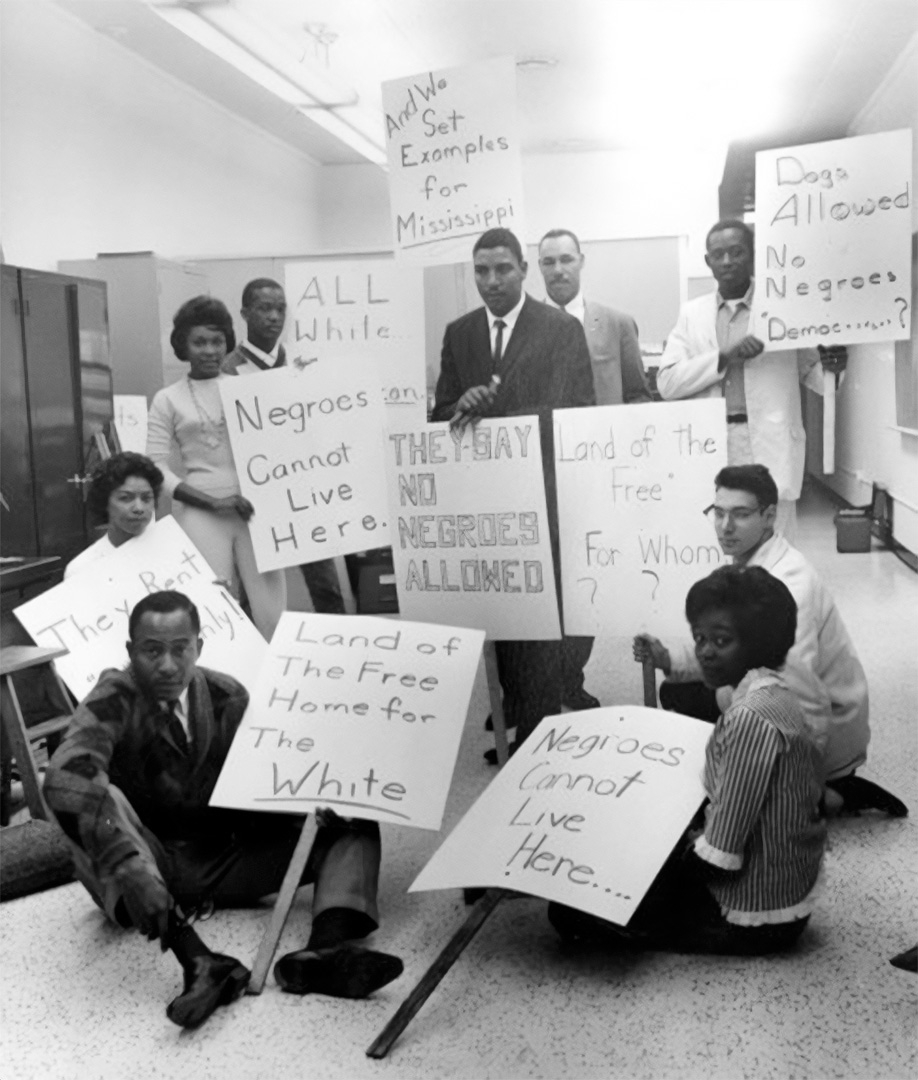 Members of the NAACP’s Housing Committee create signs in the offices of the Detroit Branch for use in a future demonstration.