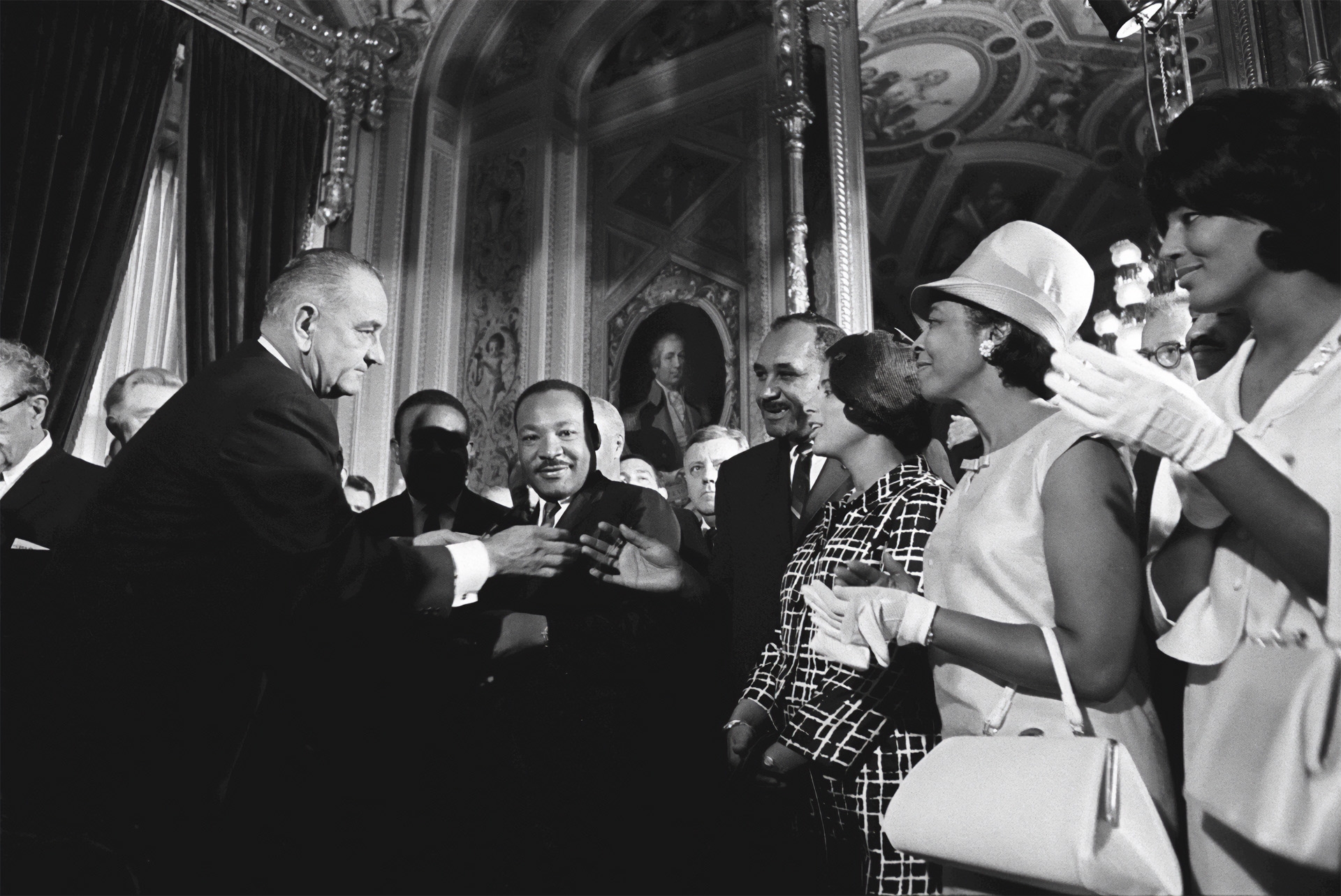 President Lyndon B. Johnson and Martin Luther King, Jr., Clarence Mitchell, and Patricia Roberts Harris.